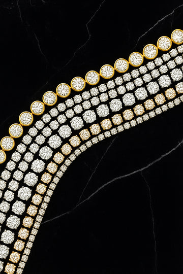 Two rows of gold and silver jewelry on a black background